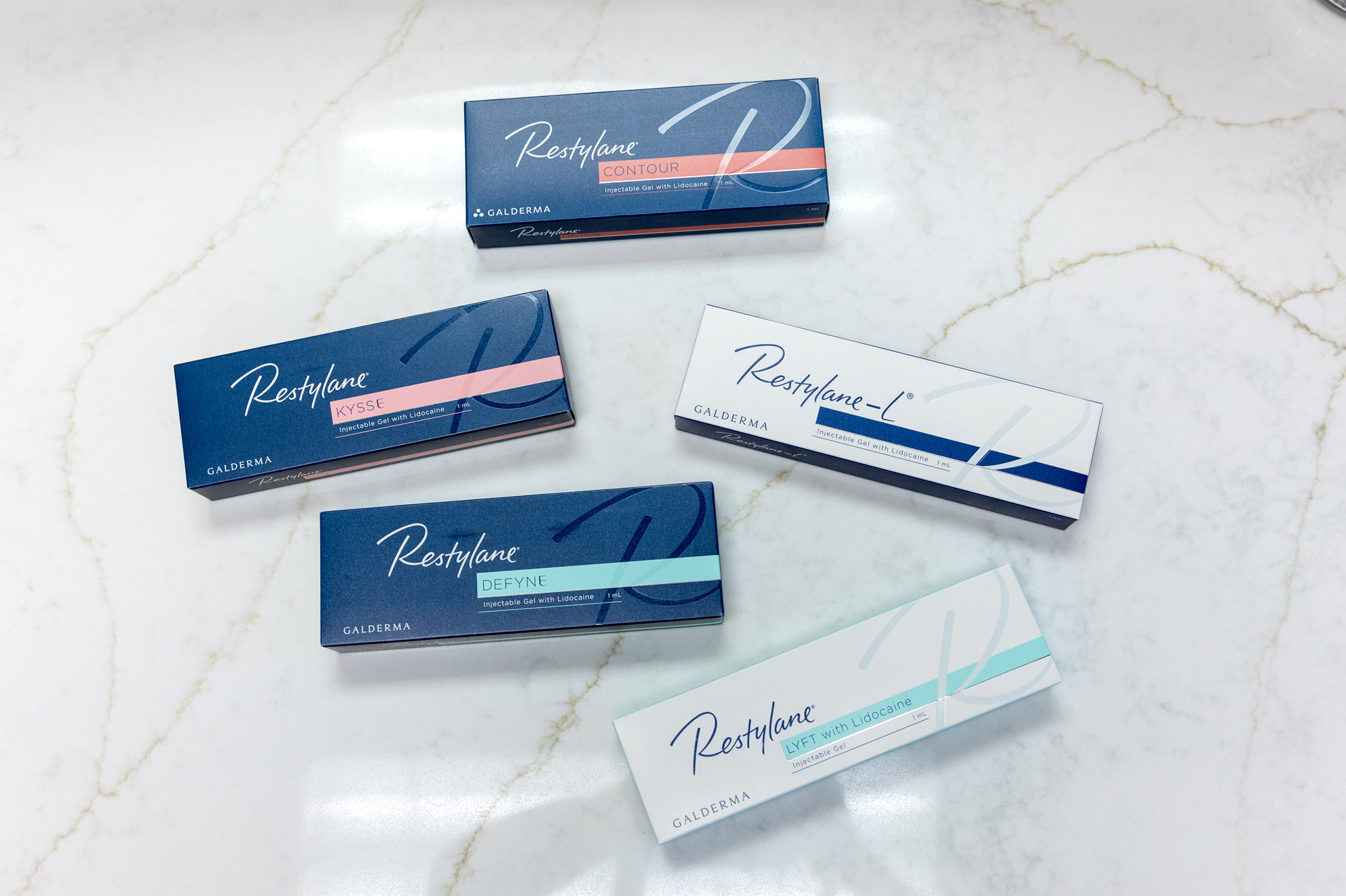 A variety of Restylane boxes on a white counter top.