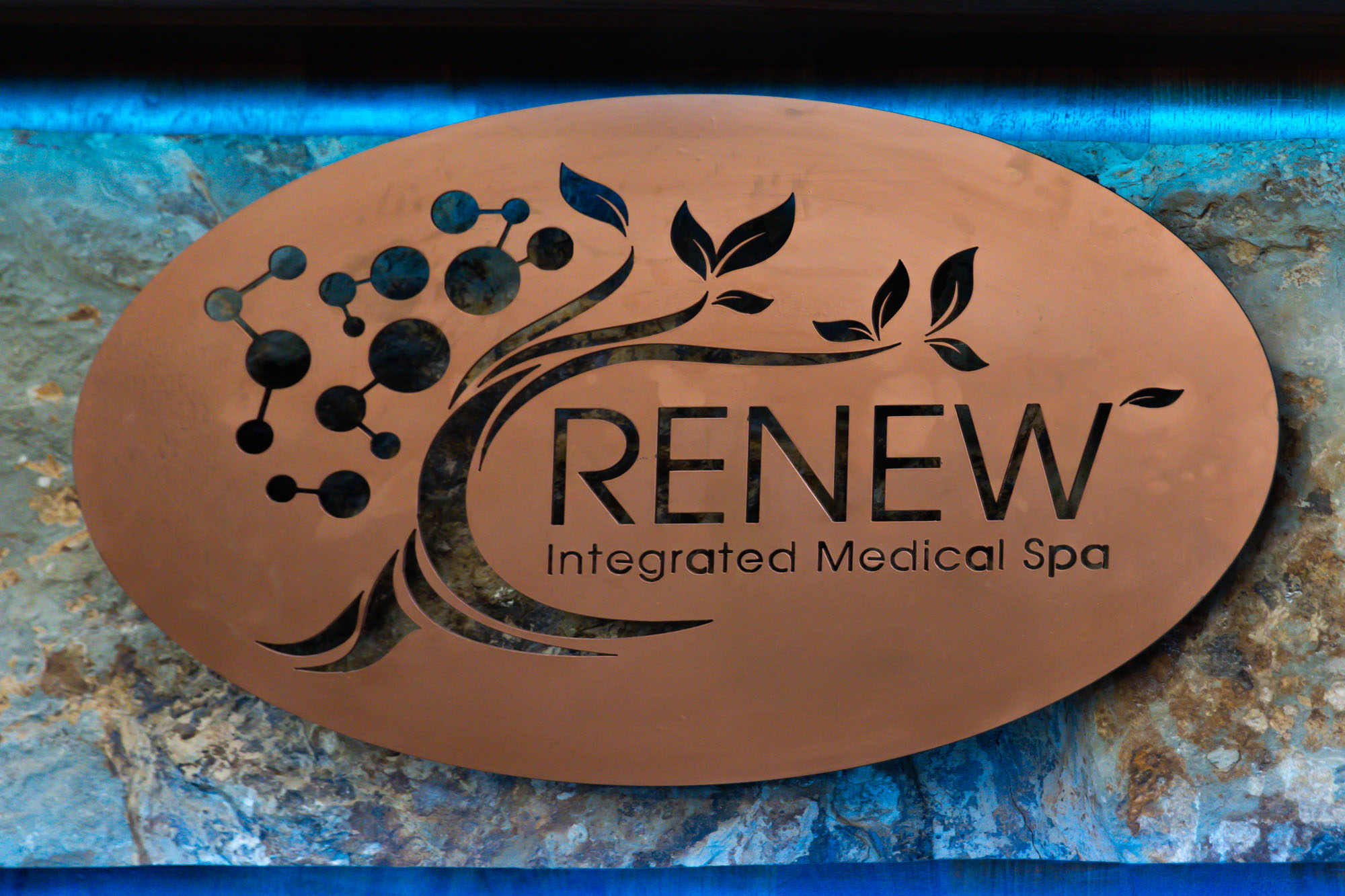 Ornate sign that reads, "Renew Integrated Med Spa."