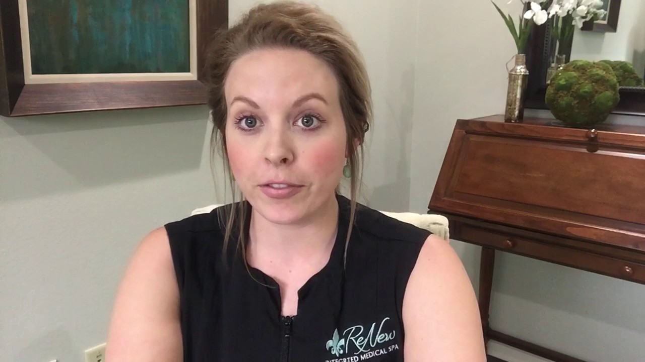 Med spa worker sitting in an office explaining treatments for stretch marks.